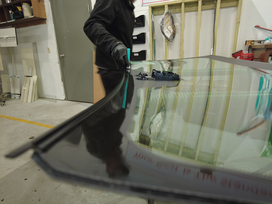 cracked-broken-windshield-replacement-south-carolina Century Glass tech prepping a new windshield for install