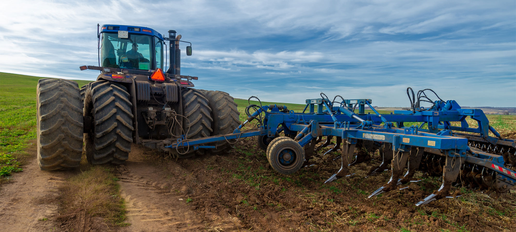 Industrial and Agricultural vehicle glass repaired. Tractor pulling plow.