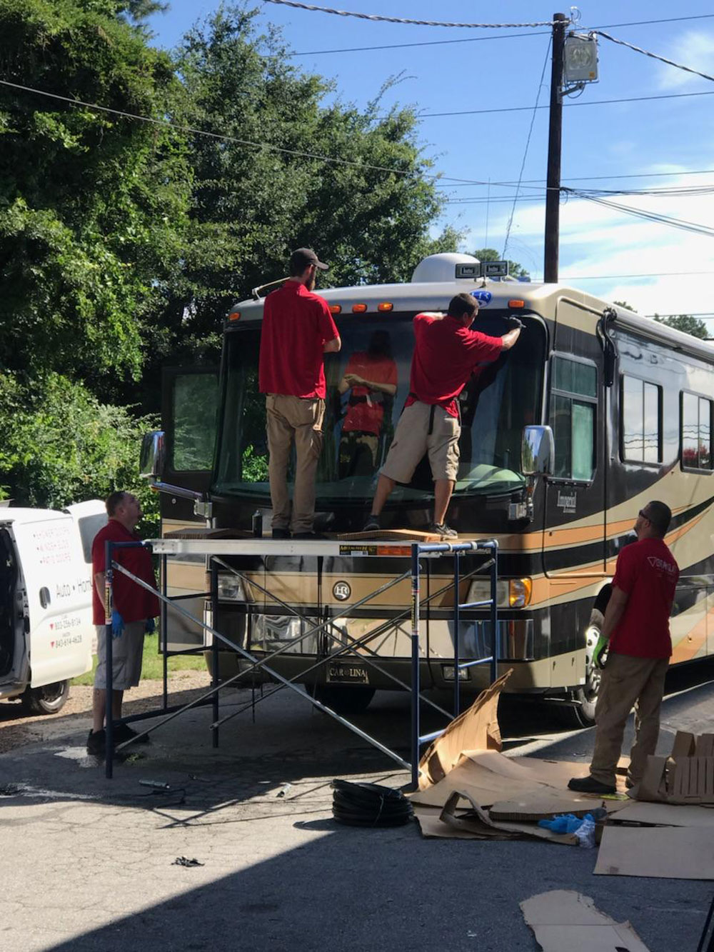 Bus sized RV getting the windshield repaired by the Century Glass team.