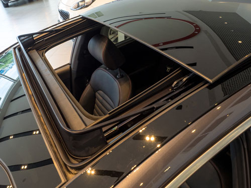sunroof open on a black car.