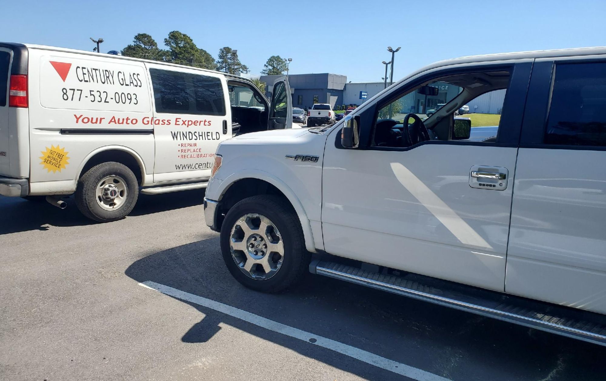mobile-auto-glass-repair-install-replacement-florence-sc Windshield on stand next to a navy blue Mustang outside home.