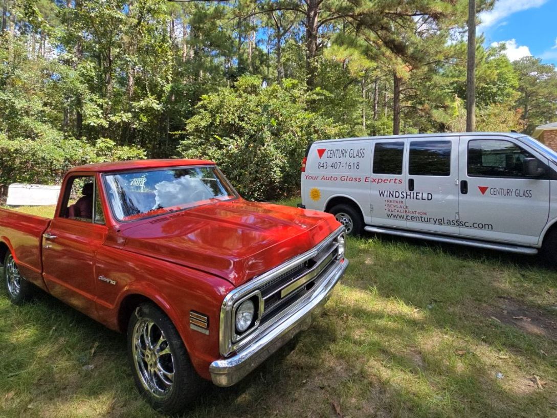 auto-glass-repairs-south-carolina-agsc-certified-technicians Century Glass' Mobile Auto Glass Repair van beside a classic 1968 Chevrolet C10.