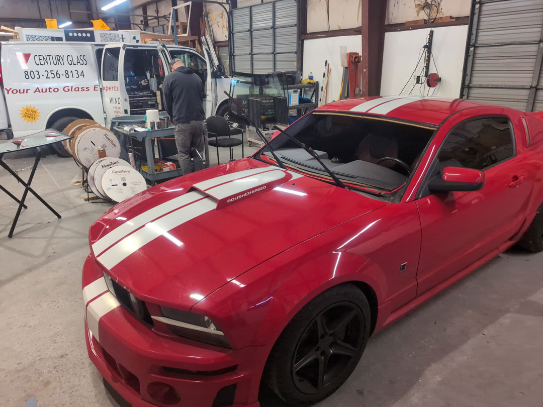 Windshield on stand in front of Dodge ram